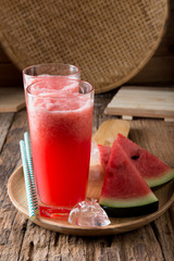 Watermelon smoothie on wood background