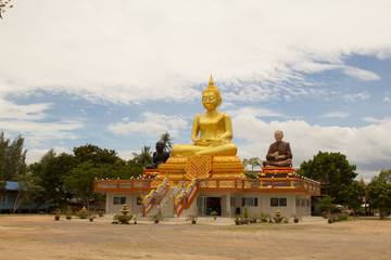 Fototapeta na wymiar The big Buddha sitting on sky background in Thailand.