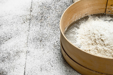 Baking background. Sieve with flour.