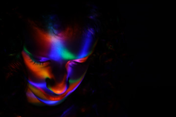Fototapeta premium abstract portrait of young girl under colorful fluorescent Neon dark lights, enigmatic style.