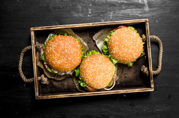 Burgers on an old tray.
