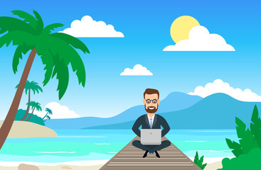 businessman freelancer working on the tropical beach with laptop