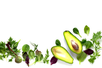 Ripe fresh avocado and mixed salad leaves isolated on white background.