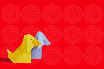Dog Origami,gold coins,money envelope over red background.Chinese New Year 2018.Chinese Lunar Year of Dog.(Foreign text means prosperity,luck and wealth)