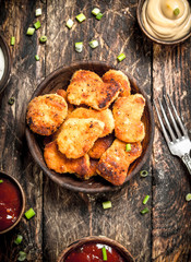 Chicken nuggets with various sauces.