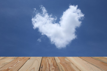 Blue sky and white heart with wooden space.