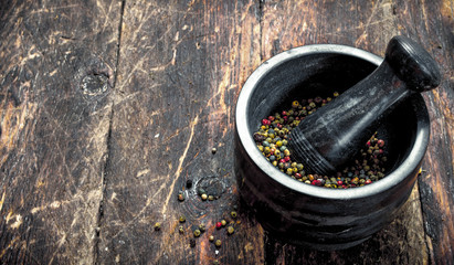 Pepper in a mortar with a pestle.