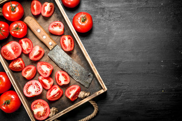 Tomatoes with old hatchet on the tray.
