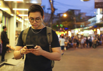 tourist man using the smartphone at night