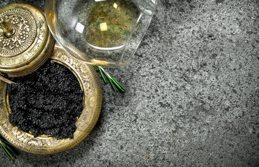 Black caviar with a glass of white wine.