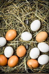 Fresh chicken eggs on an old tray.