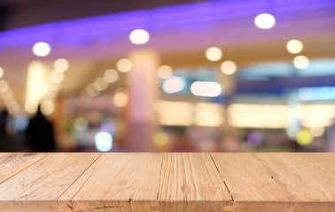 Empty wooden table in front of abstract blurred background of coffee shop . can be used for display or montage your products.Mock up for display of product.