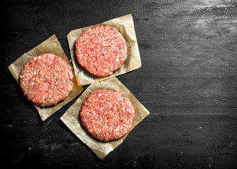 Fototapeta na wymiar Raw burger from pork and beef on paper.