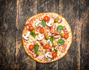 Fresh homemade pizza. On wooden background