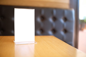 Menu frame standing on wood table in Bar restaurant cafe. space for text marketing promotion.