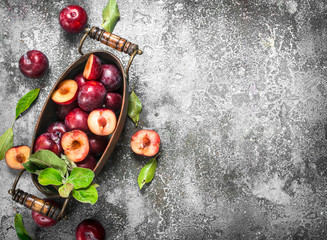Ripe plums in a bowl.