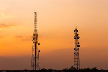 Communication towers as silhouettes in front a gorgeous sunset.