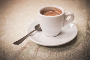 Small white cup of espresso coffee, vintage