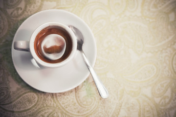 Top view of small white cup with espresso
