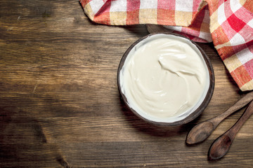 Natural yogurt in a bowl with a spoon.