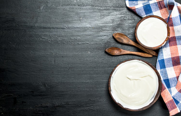Fototapeta na wymiar Natural milk yogurt in a bowl with a spoon.
