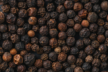 Black pepper peas for cooking. Photographed close-up on a dark background.