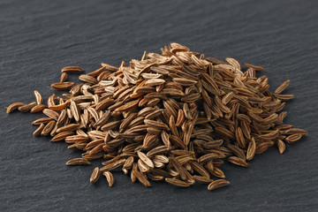 Fennel seeds for cooking. Photographed close-up on a dark background.