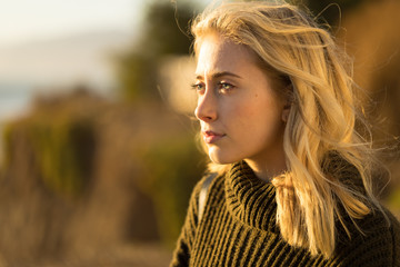 Young caucasian woman looking far away thinking
