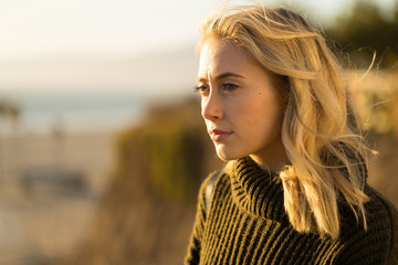 Young caucasian woman looking far away thinking
