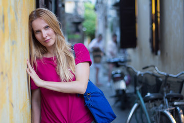young woman traveller in causal clothing posing on street