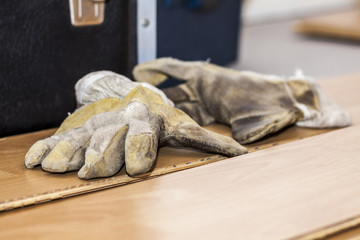 Pair of used gloves lying on removed laminate