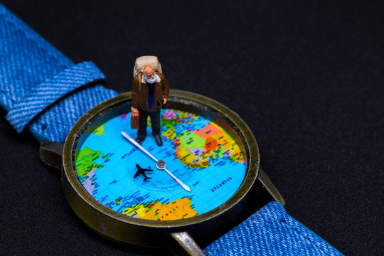Old man with backpack and world map watches. Around world travel photo banner.