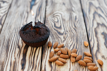 Cake on a wooden background next to almonds