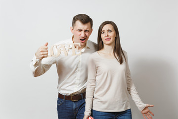 Young couple in love. Man and woman with wooden word Love isolated on white background. St. Valentine's Day International Women's Day birthday holiday concept. Quarrel divorce break up of relationship