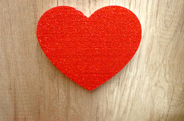 Glittering red heart, on natural wooden background