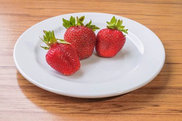 Fresh strawberry on a white plate
