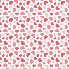 Cute valentine's day seamless pattern background with red and pink hearts.
