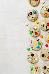 Homemade Cookies with Colorful Chocolate Candies on Bright Background, Copy Space