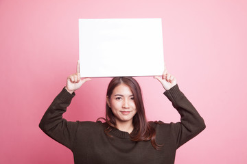 Young Asian woman with white blank sign.