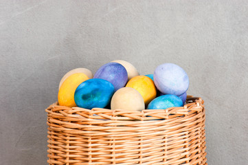 Colorful easter eggs in the wicker basket
