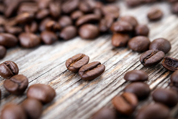 a lot of coffee beans on wooden ground