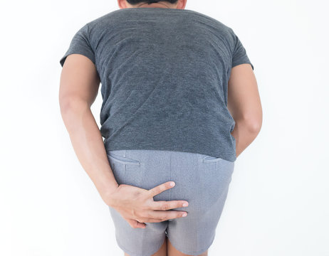 Young man has pain in the butt, Hemorrhoids, Anal disorders.