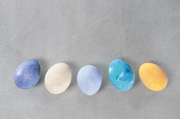 Gray textured background with colorful Easter eggs