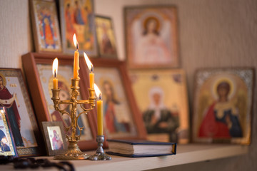 candle against the background of orthodox icons