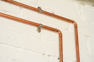 A vintage outlet and electrical wiring in a copper tube.