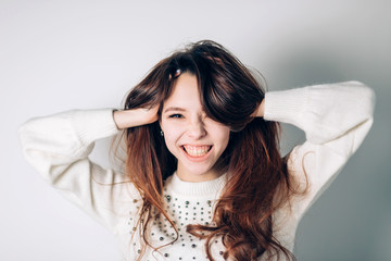 Naklejka premium Smiling happy woman. Funny young girl on a white background. Sincere positive emotions.