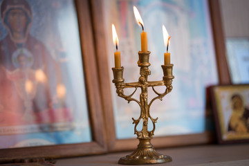candle against the background of orthodox icons