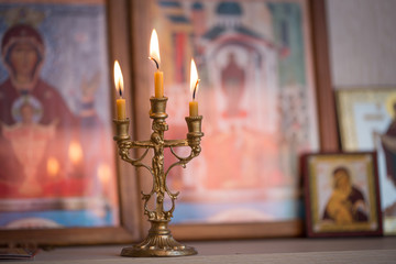 candle against the background of orthodox icons