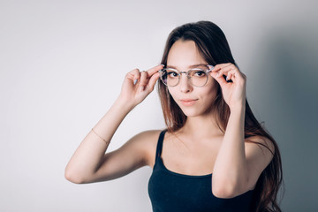 Portrait of a young Girl in glasses, a woman looking at the camera