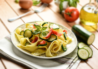 egg pappardelle with zucchini and tomato - selective focus